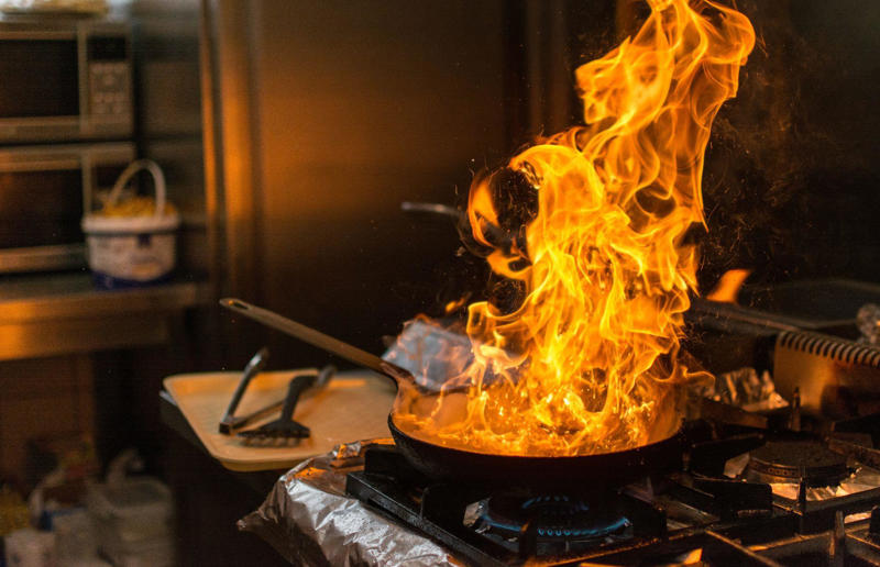 2. Pouring water over a grease fire 37. Pouring hot liquids into cold glassware, 36. Not rotating store cupboard items, 35. Overcrowding the refrigerator, 34. Microwaving liquids for too long, 33. Lining the bottom of the oven with aluminium foil, 32. Leaving plates or cookware on unstable surfaces, 31. Using glassware on the stove, 30. Not securing cutting boards or mixing bowls, 29. Never checking the refrigerator temperature, 28. Using plastic containers in the microwave, 27. Using the same utensil for everything, 26. Not using the oven extractor fan, 25. Letting your pets roam the kitchen while you cook, 24. Storing heavy items on high shelves, 23. Not storing leftover food correctly, 22. Overheating non-stick cookware, 21. Using damaged non-stick cookware, 20. Going barefoot while cooking, 19. Storing raw meat and ready-to-eat food together, 18. Not storing knives properly, 17. Thawing meat at room temperature, 16. Not cleaning the oven extractor hood filter, 15. Not washing your hands, 14. Using knives carelessly, 13. Stacking dishwashers incorrectly, 12. Using one towel for everything, 11. Washing raw meat in the sink, 10. Storing cleaning products near food, 9. Not separating raw meat from ready-to-eat foods, 8. Using appliances incorrectly, 7. Getting distracted when cooking, 6. Using wet or damaged oven gloves and towels, 5. Touching electrical appliances with wet hands, 4. Wearing loose clothing when cooking, 3. Leaving the stove unattended, 2. Pouring water over a grease fire