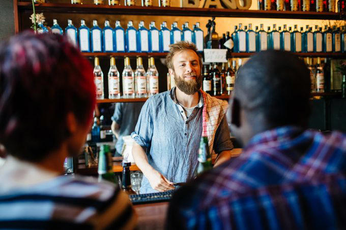 The dos and don’ts of bar etiquette, Asking them to do a shot with you, Picking up your drink before they give it to you, Cleaning up broken glass, Itemizing and splitting a tab, Stuffing napkins, straw wrappers or other trash into your cup, Telling them your life story, Asking them out, Reaching over or behind the bar to grab something quickly, Buying a round of drinks, Asking them to “surprise you” with a drink, Requesting a custom cocktail or ordering off-menu, Using beverage napkins to clean up a spill, Handing them a wad of cash, Getting creative with the tip, Not bothering them with safety concerns, Keeping things simple without a menu, About the experts, Why trust us