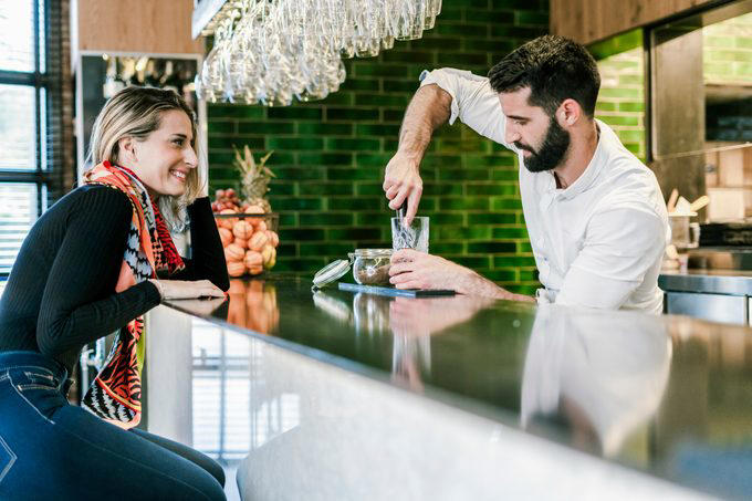 The dos and don’ts of bar etiquette, Asking them to do a shot with you, Picking up your drink before they give it to you, Cleaning up broken glass, Itemizing and splitting a tab, Stuffing napkins, straw wrappers or other trash into your cup, Telling them your life story, Asking them out, Reaching over or behind the bar to grab something quickly, Buying a round of drinks, Asking them to “surprise you” with a drink, Requesting a custom cocktail or ordering off-menu, Using beverage napkins to clean up a spill, Handing them a wad of cash, Getting creative with the tip, Not bothering them with safety concerns, Keeping things simple without a menu, About the experts, Why trust us