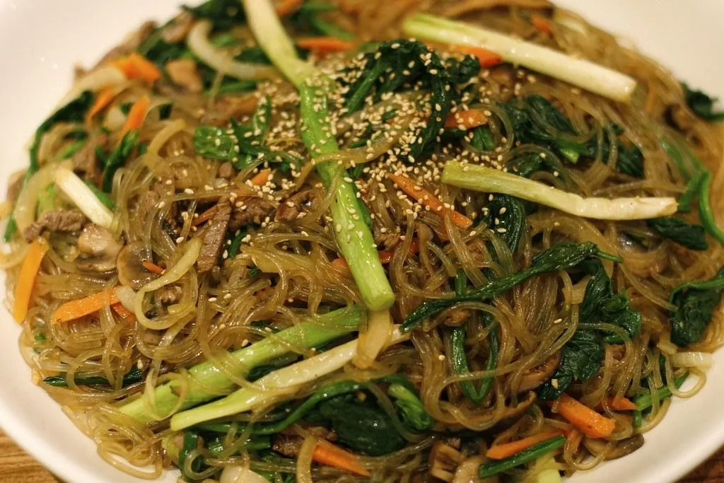 Japchae, 1. Hot and Spicy Cheese Tteokbokki, 2. Samgyetang, 3. Kimchi Boggeumbap and Cheese, 4. Jjajangmyeon, 5. Jjamppong, 6. Japchae, 7. Rabokki, 8. Ojingeo Bokkeum, 9. Bulgogi, 10. Dak Gan Jeong