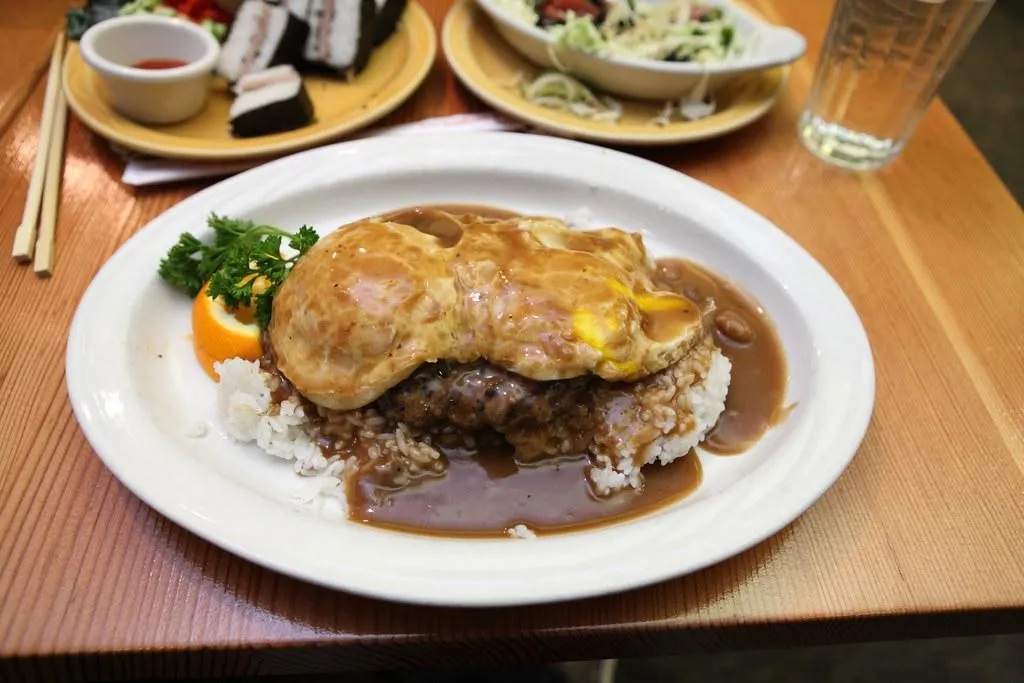 Loco moco, 3. Kalua Pork, 4. Lau Lau, 5. Spam Musubi, 6. Saimin, 7. Loco moco, 8. Lomi lomi salmon, 9. Manapua, 10. Chicken long rice 