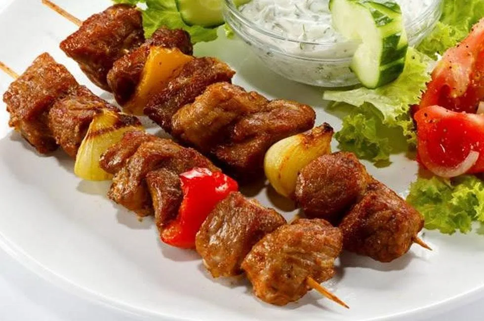 Shashlik, 1. Borscht, 2. Pelmeni, 3. Blini, 4. Pirozhki, 5. Shashlik, 6. Kholodets, 7. Oladyi, 8. Solyanka, 9. Okroshka, 10. Beef Stroganoff