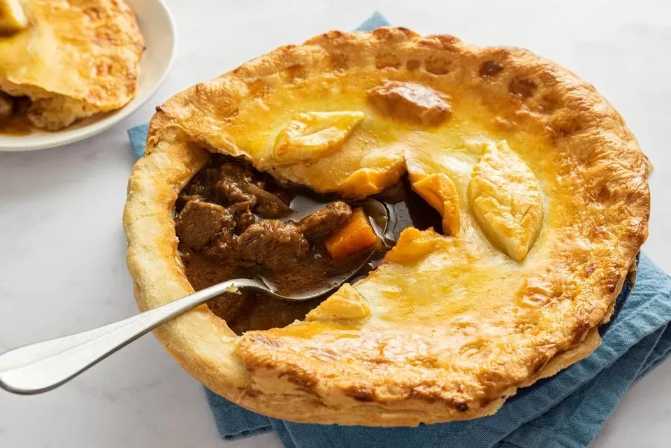 Beef and Guinness Pie, 1. Full Irish Breakfast, 2. Irish Apple Cake, 3. Champ, 4. Soda Bread, 5. Colcannon, 6. Stobhach/ Irish Stew, 7. Coddle, 8. Boxty, 9. Beef and Guinness Pie, 10. Barmbrack