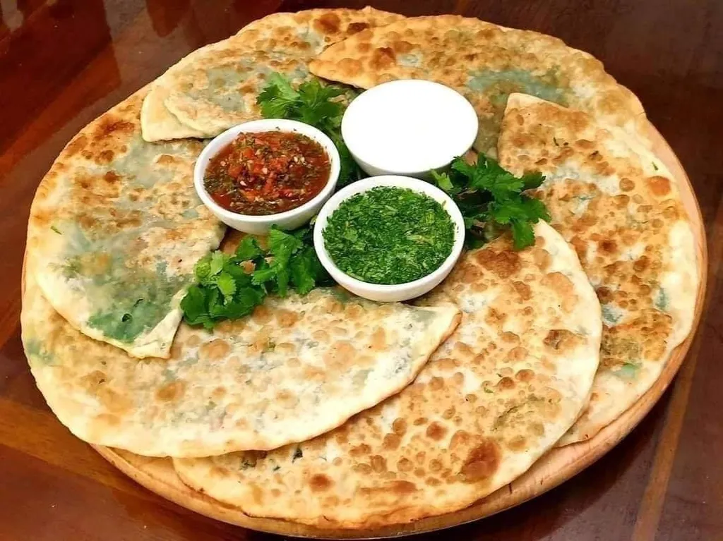 Bolani, 1. Kabuli Pulao, 2. Mastawa, 3. Lavash, 4. Maas Pulao, 5. Bolani, 6. Chopan Kabob, 7. Mantu (Manto), 8. Kofta Challow, 9. Shord Nakhod, 10. Aush