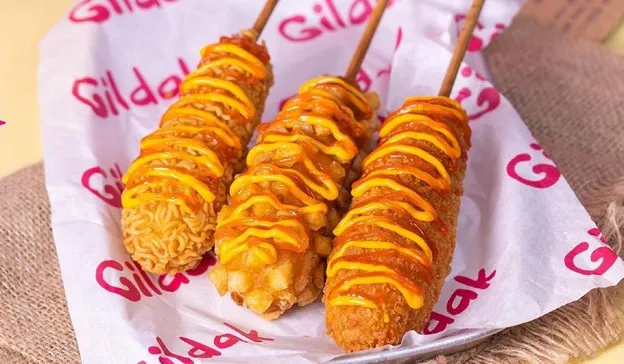 Hang Gang Corn Dog, 1. Itaewon Crispy Chicken, 2. Itaewon Mozzy Chicken, 3. Busan O-Bokki, 4. Gangnam Cheese Ball, 5. Seoul Chicken Skin, 6. Hang Gang Corn Dog, 7. Hongdae Crispy Dory, 8. Busan Odeng, 9. Jeju Squid Nugget, 10. Myeongdong Mix Bowl, 11. Incheon Chicken Wings