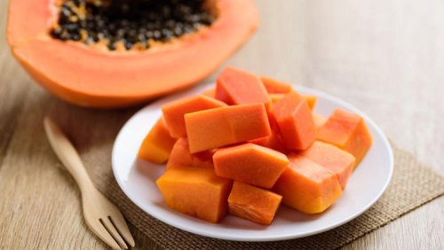 Sliced ripe papaya fruit on plate and fork ready to eating&amp;comma; Tropical fruit