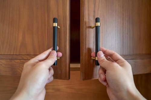 13 Tips To Install Cabinet Hardware Perfectly Every Time Gettyimages 1389698183 Ft, Use the Door Rail as a Guide, Hide Old Holes With Back Plates, Make a Simple Drawer Template, Two-Sided Templates Prevent Tear-Out, Use Thread Sealant to Keep the Screws Tight, Mix Putty to Match, Install Hardware Higher on the Lowest Drawer, Perfect Finish Touch-Ups, Top 13+ Tips To Install Cabinet Hardware Perfectly Every Time