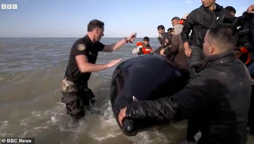 Migrants react with fury as French police slash their boat and drag them back to shore