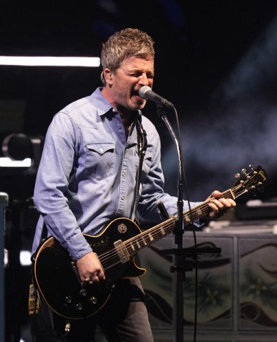 Oasis take to stage for first gig in 16 years to jumping crowd and flying cups