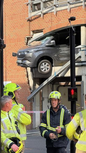Pedestrians rushed to hospital after being hit by falling rubble when van ploughed through wall