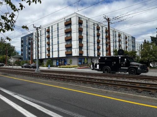 Suspect surrenders to police after hours-long standoff on apartment roof in Portland
