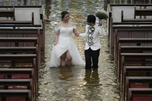 'An extraordinary wedding': Couple tie the knot in a flooded church amid typhoon in the Philippines
