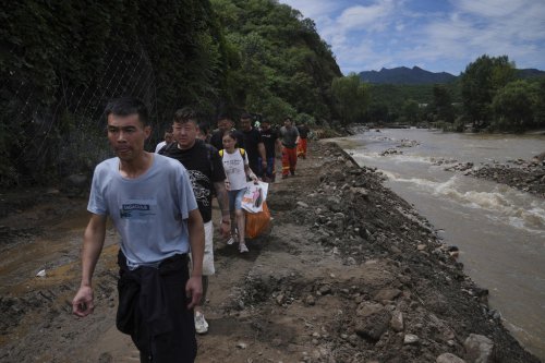 Heavy rain causes flooding, evacuations and at least 38 deaths around Beijing region