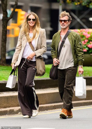 Elle Macpherson's hair extensions are exposed as she heads out with her partner