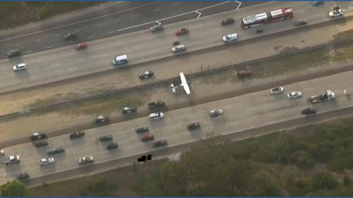 A small plane lands on Interstate 15 in San Diego
