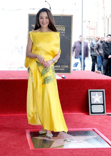 Michelle Yeoh glows in sunflower yellow as she receives her Hollywood star
