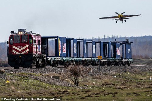 Watch the moment a pilot lands a plane on a train travelling at 75mph - before taking off again