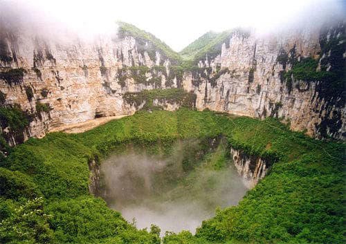 A hidden world inside Earth: This giant sinkhole is in China and has its own weather, wildlife