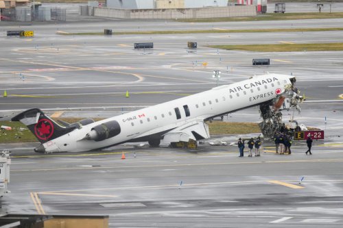 Flight attendant thrown, still strapped in seat survives LaGuardia crash