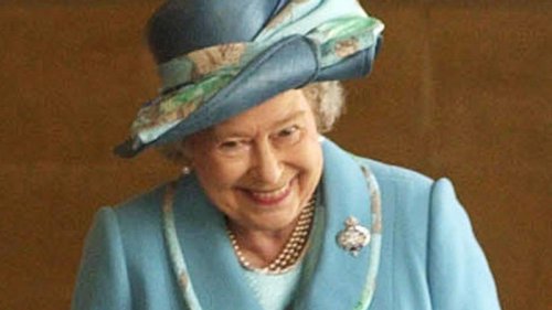 The real story behind Queen Elizabeth II's rare photo giggling at Prince Philip in uniform