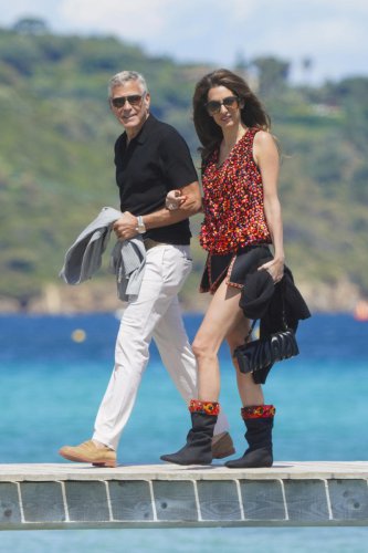 Amal Clooney celebrates George&rsquo;s 65th birthday in daring top and high-slit miniskirt