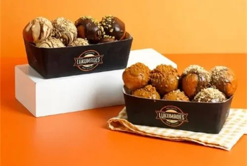 1. Half Half Box, 2. Golden Caramel, 3. Plane Jane, 4. Golden Maple, 5. Oreo Balls, 6. Lotus Crunch, 7. Twix Fix, 8. Snickers, 9. Choco Latte, 10. Tiger Banana, 11. Matcha Balls, 12. Bueno, Top 12+ Menu Paling Enak dan Terlaris di Donat Lukumades